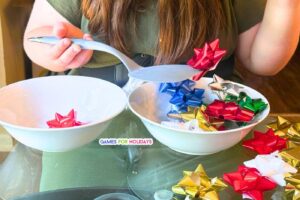 person playing Christmas Bow Spatula Game at Christmas party for games for holidays